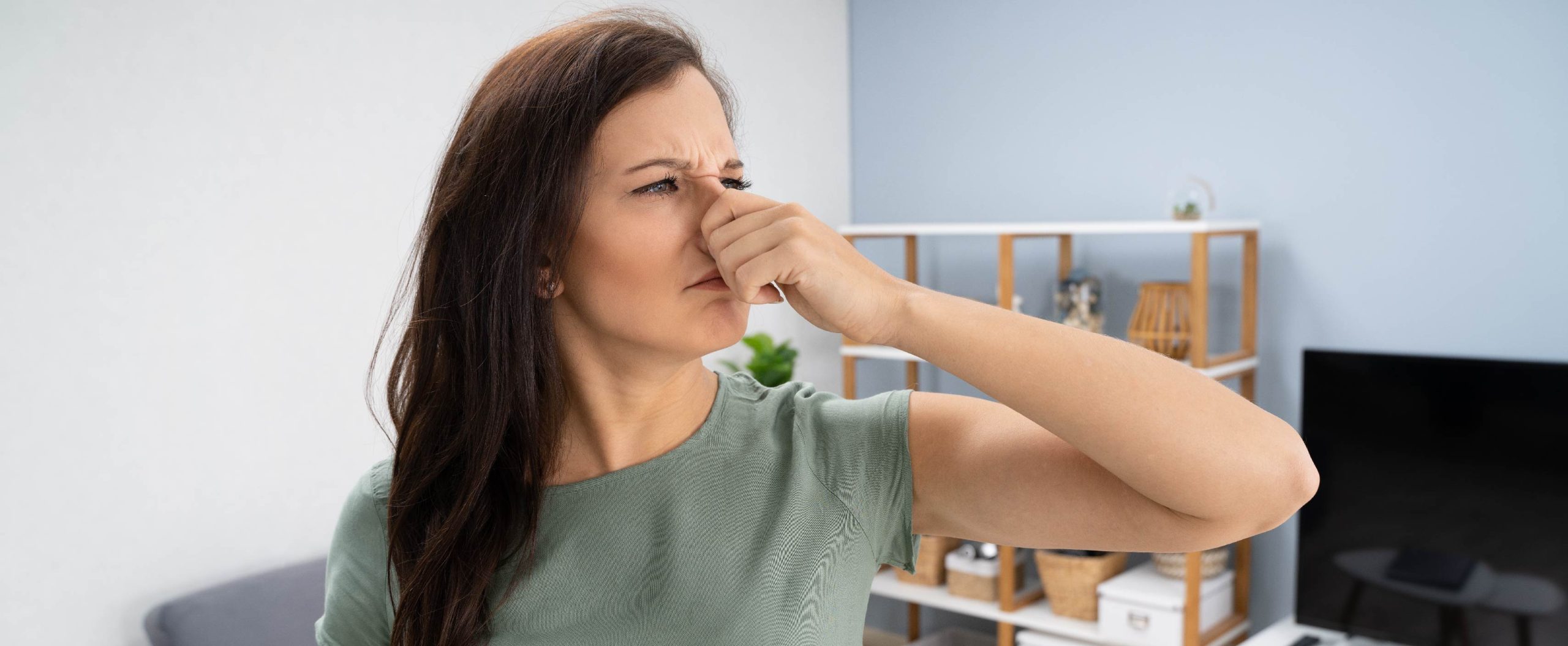 woman plugging her nose